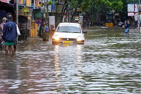Cyclone Fengal: A car moves on a waterlogged road