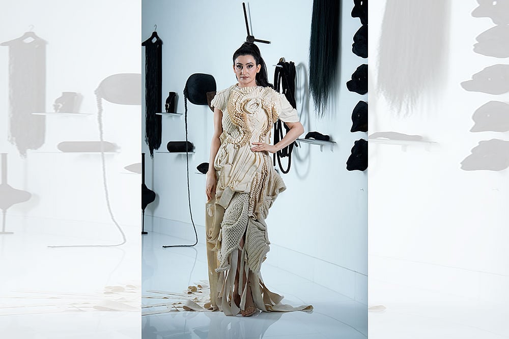 Standing Tall: Shalini Passi in a Samant Chauhan outfit, inspired by Patna-based artist Rajat Ghosh’s ‘Evolution of Man’ series. She is standing in front of Delhi-based artist Anita Dube’s 1998 artwork ‘The Theatre of Sade’ - Photo: Vikram Sharma