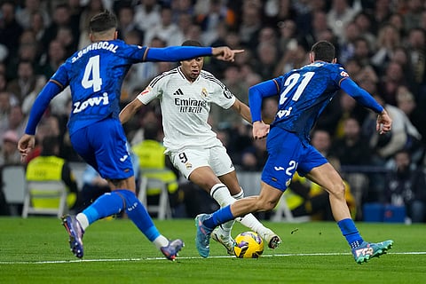 La liga 2024-25: Real Madrid's Kylian Mbappe is challenged by Getafe's Juan Berrocal and Juan Iglesias