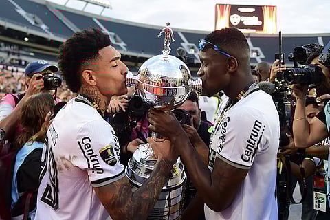 Copa Libertadores Final: Igor Jesus of Brazil's Botafogo, left, and teammate Luiz Henrique kiss the trophy