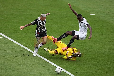 Copa Libertadores Final: Luiz Henrique of Botafogo, right. is fouled by goalkeeper Everson of Atletico Mineiro
