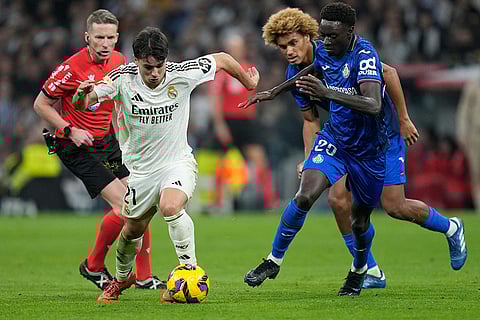 La liga 2024-25: Real Madrid's Brahim Diaz, left, runs with the ball past Getafe's Jesus Santiago