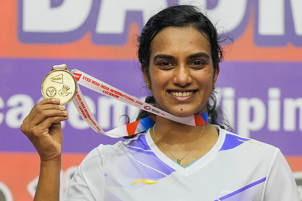 | Photo: PTI/Nand Kumar : Syed Modi International 2024 Badminton: Badminton player P V Sindhu displays her gold medal