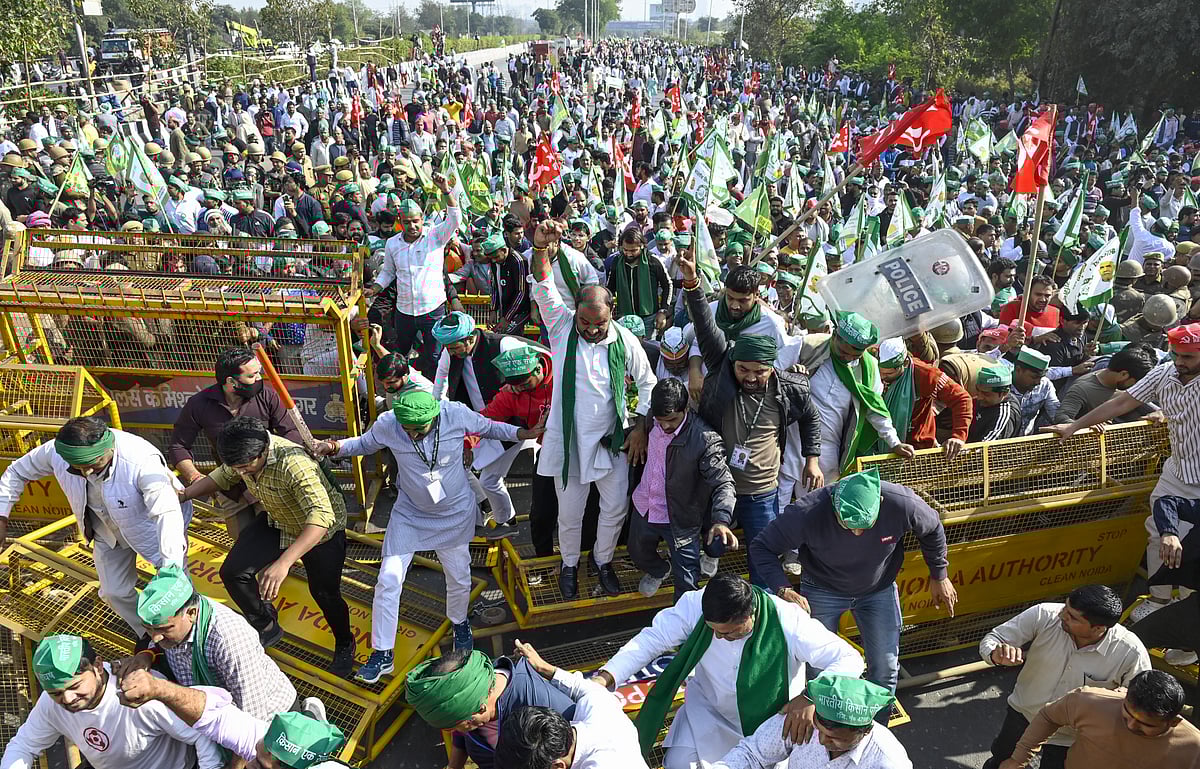PTI : Farmers and Kisan Ekta Sangh members break police barricades during their protest march demanding for the expansion of minimum support prices (MSP) and other benefits, in Noida, Monday, Dec. 2, 2024.