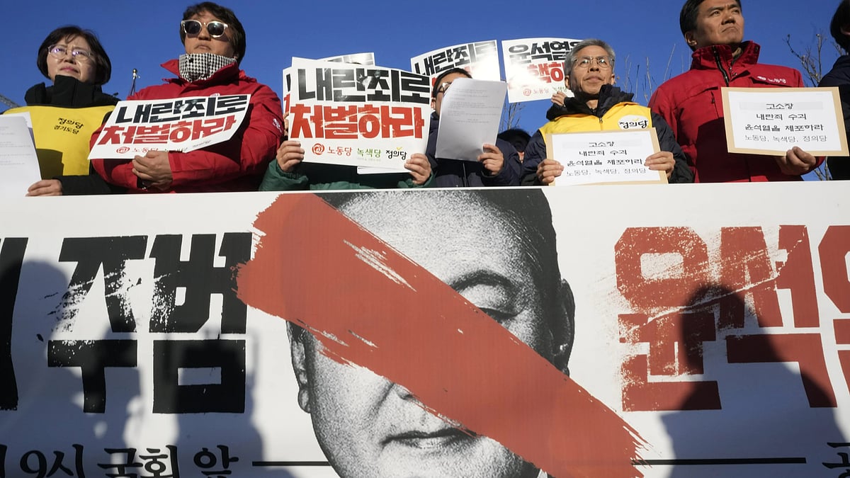 Protesters stage a rally to demand South Korean President Yoon Suk Yeol to step down in front of the National Assembly in Seoul, South Korea, Wednesday, Dec. 4, 2024. The signs read "Punish." - AP Photo/Ahn Young-joon