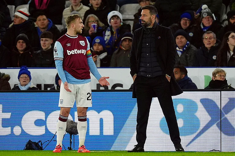 English Premier League: Ruud van Nistelrooy, right, waits with West Ham United's Jarrod Bowen on a VAR check - | Photo: Mike Egerton/PA via AP