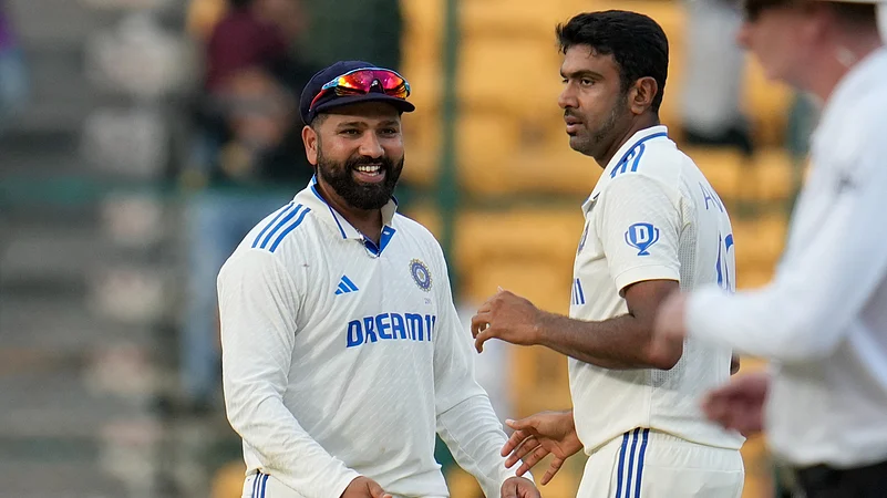 Indias Ravichandran Ashwin, right, celebrates with captain Rohit Sharma. AP Photo.jpg