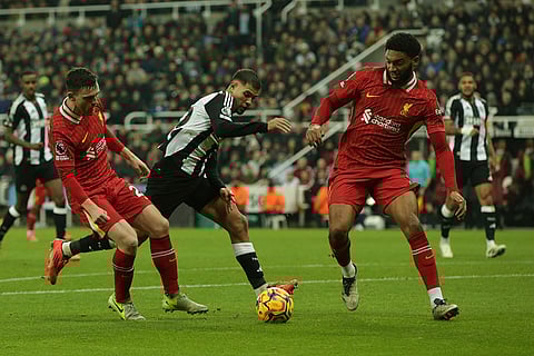 EPL 2024-25: Newcastle's Bruno Guimaraes duels for the ball with Liverpool's Andrew Robertson and Joe Gomez