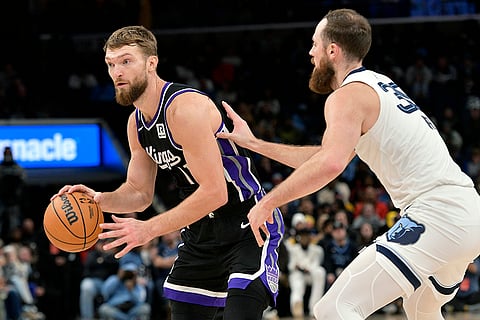 NBA 2024-25: Kings forward Domantas Sabonis (11) handles the ball against Grizzlies center Jay Huff (30)