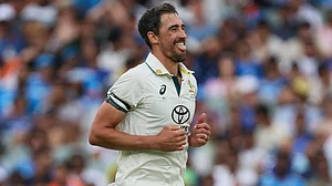AP/James Elsby : Mitchell Starc celebrates the wicket of Harshit Rana during day one of the second Test between Australia and India at the Adelaide Oval.