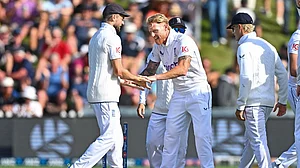 AP/Kerry Marshall : Ben Stokes is congratulated by teammate Joe Root, left, after taking the wicket of New Zealand's Tom Latham during during day one of the 2nd Test between New Zealand and England at the Basin Reserve in Wellington.