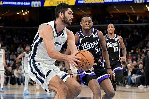 NBA 2024-25: Grizzlies forward Santi Aldama handles the ball ahead of Kings guard De'Aaron Fox