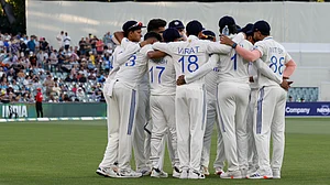 AP Photo/James Elsby : Indian players huddle before the start of Australia's innings during day one of the second cricket test match between Australia and India at the Adelaide Oval in Adelaide.