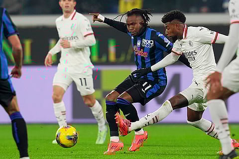 Italy Serie A 2024-25: AC Milan's Emerson Royal, right, fight for the ball with Atalanta's Ademola Lookman
