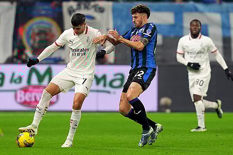 Italy Serie A 2024-25: AC Milan's Alvaro Morata, left, challenge for the ball with Atalanta's Matteo Ruggeri