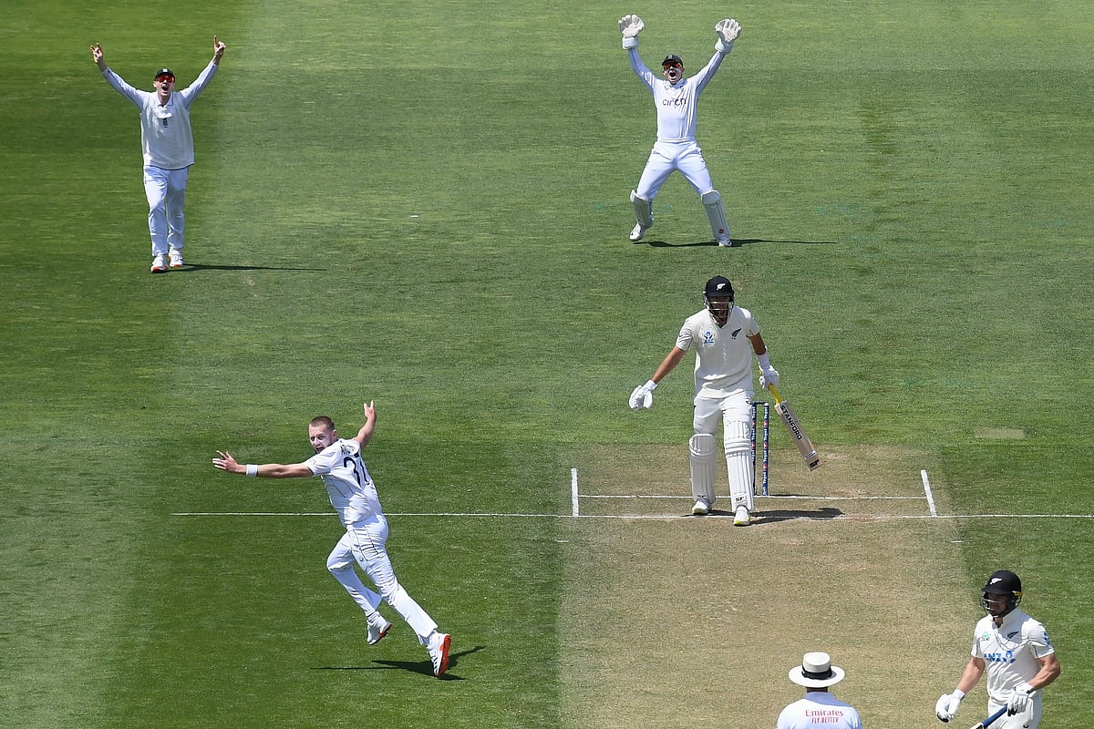 (Kerry Marshall/Photosport via AP) : England's Gus Atkinson, bottom left, celebrates after taking a hat trick during play on day two of the second cricket test between New Zealand and England at the Basin Reserve in Wellington, New Zealand, Saturday, Dec.7, 2024. 