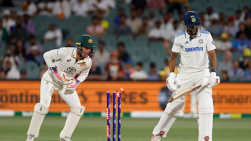 Australias wicketkeeper Alex Carey, left, breaks the stumps. AP Photo