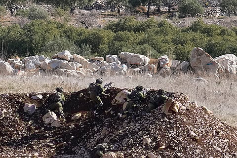 Israeli soldiers take position near Alpha Line
