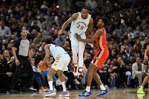 NBA Pelicans vs Spurs Basketball: Pelicans' Yves Missi tangles with Spurs' Charles Bassey (28) and Devin Vassell