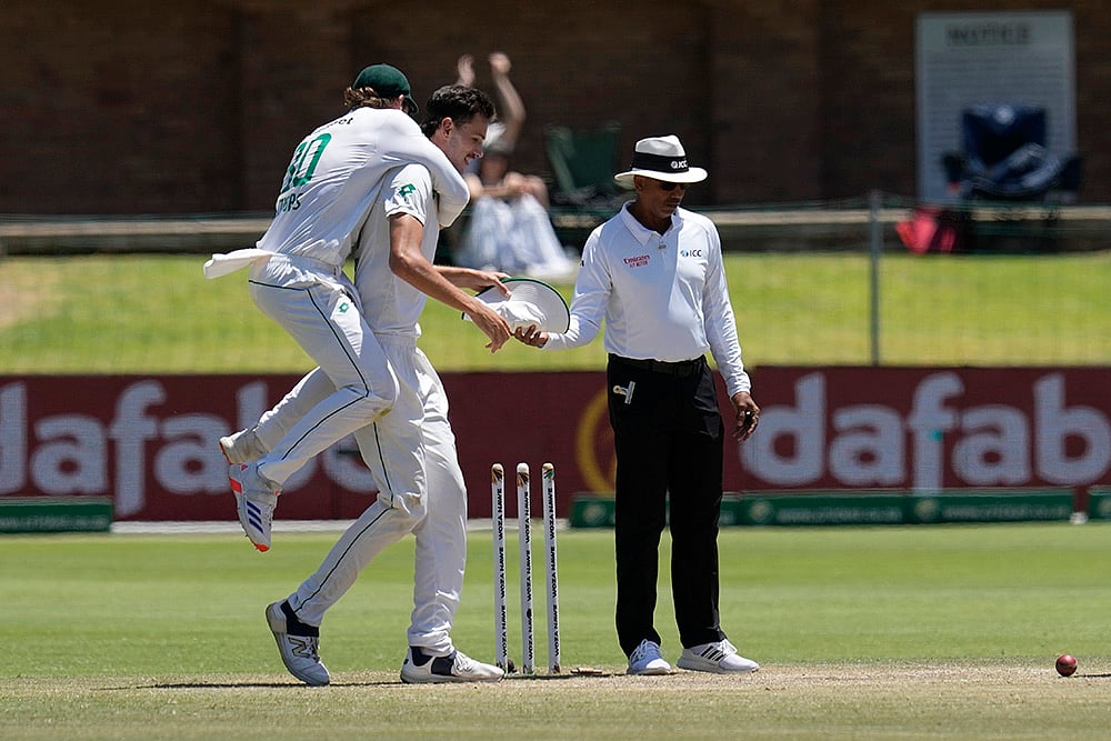 | Photo: AP/Themba Hadebe : RSA Vs SL, 2nd Test: South Africa's Tristan Stubbs, left, jumps onto teammate Marco Jansen for taking the winning wicket 