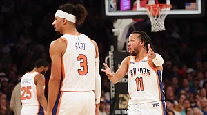 AP Photo/Heather Khalifa : New York Knicks' Jalen Brunson reacts as he speaks to the official along with teammate Josh Hart during the second half of an NBA basketball game against the Detroit Pistons.