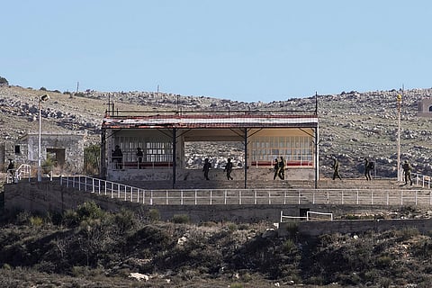 Israeli soldiers patrol near Alpha Line