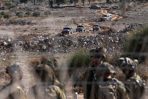Israeli armored vehicles maneuver near Alpha Line