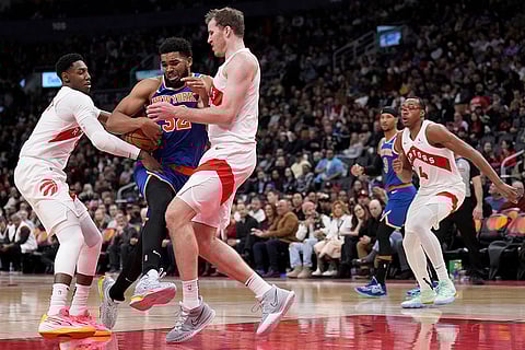NBA Basketball: Knicks Karl-Anthony Towns drives into Raptors center Jakob Poeltl