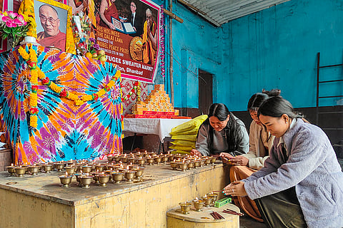 Tibetan people pray for the Dalai Lama