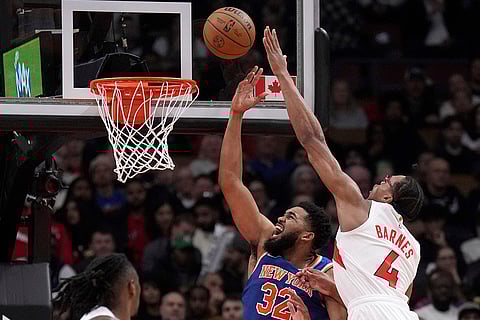 NBA Basketball: Raptors forward Scottie Barnes (4) fouls Knicks center Karl-Anthony Towns