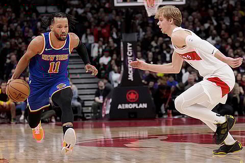 NBA Basketball: Knicks guard Jalen Brunson (11) drives past Toronto Raptors guard Gradey Dick (1)