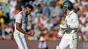 | Photo: AP/James Elsby : IND Vs AUS 2nd Test Day 2: India's Mohammed Siraj, left, celebrates the dismissal of Australia's Alex Carey