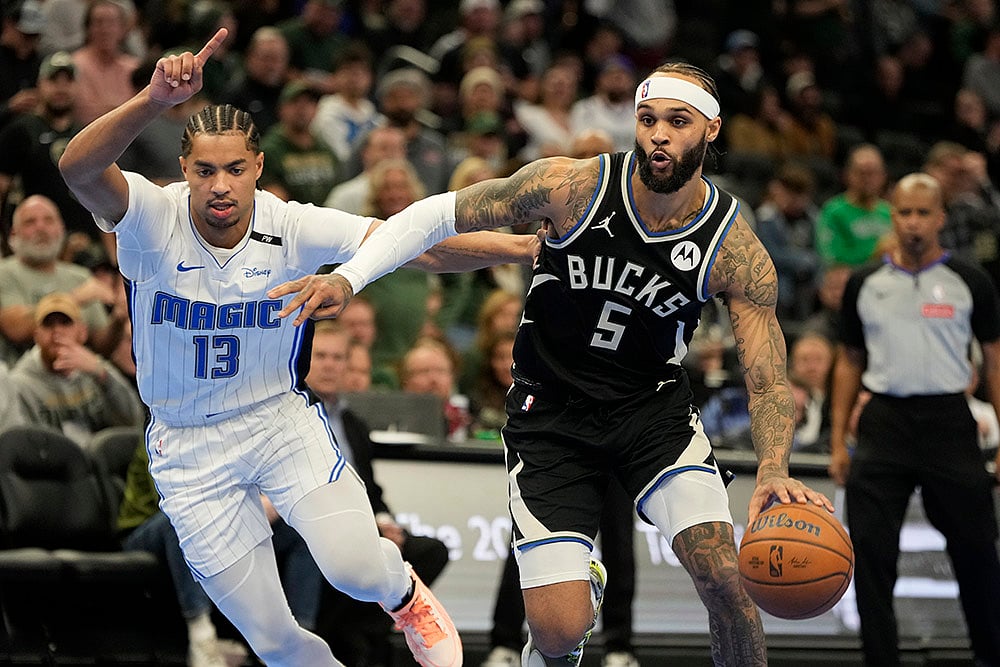 | Photo: AP/Morry Gash : NBA Cup quarterfinals: Bucks' Gary Trent Jr. tries to get past Magic's Jett Howard 