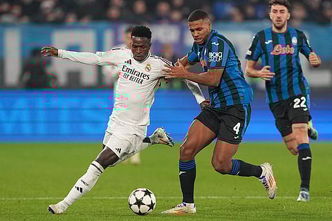 Champions League 2024-25: Real Madrid's Vinicius Junior, left, and Atalanta's Isak Hien fight for the ball