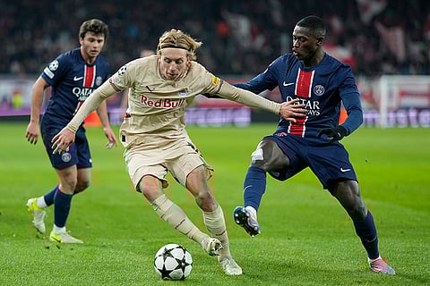 Champions League 2024-25: Salzburg's Mads Bidstrup and PSG's Nuno Mendes battle for the ball