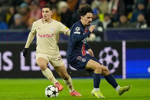 Champions League 2024-25: Salzburg's Oscar Gloukh, left, and PSG's Vitinha battle for the ball