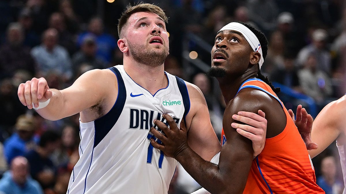 Luka Doncic battles with Luguentz Dort.
