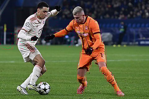 Champions League 2024-25: Bayern's Jamal Musiala, left, and Shakhtar's Oleksandr Zubkov challenge for the ball