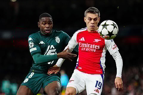 UEFA Champions League: Arsenal's Leandro Trossard, left, and Monaco's Eliot Matazo challenge for the ball
