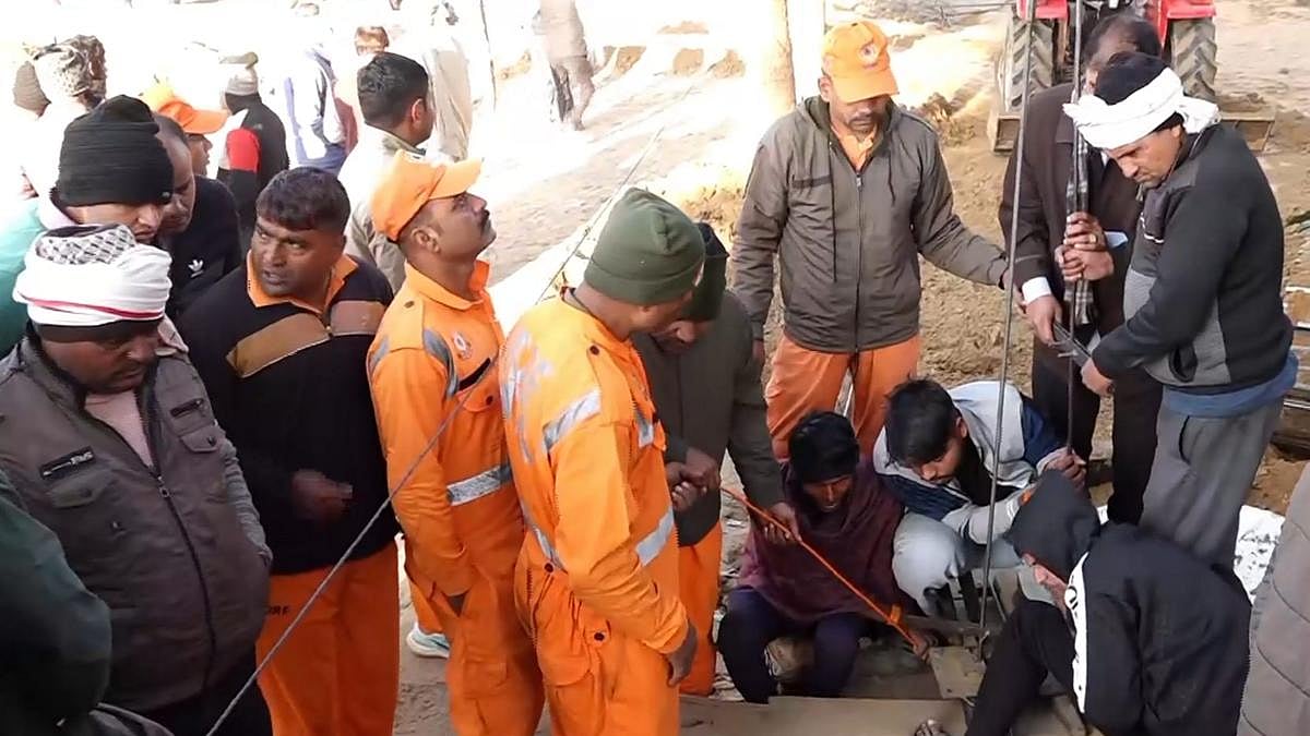 PTI : Rescue workers attempting to pull out the 5 year old boy |