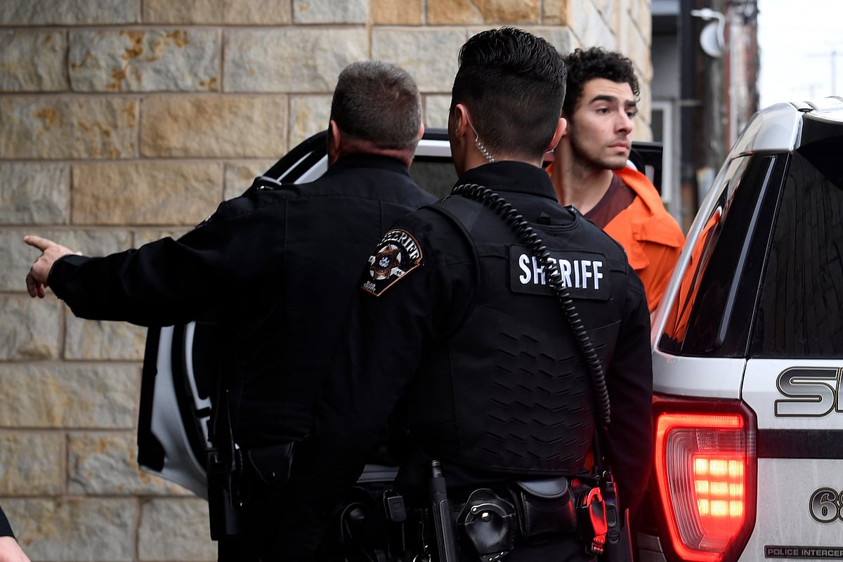 Murder suspect of UnitedHealthcare CEO, Luigi Nicholas Mangione is escorted into Blair County Courthouse, Tuesday, Dec. 10, 2024, in Hollidaysburg, Pa. - AP Photo/Gary M. Baranec