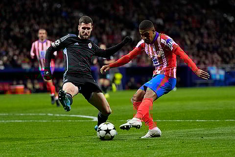 UEFA Champions League: Slovan's Kenan Bajric, left, and Atletico Madrid's Samuel Lino vie for the ball