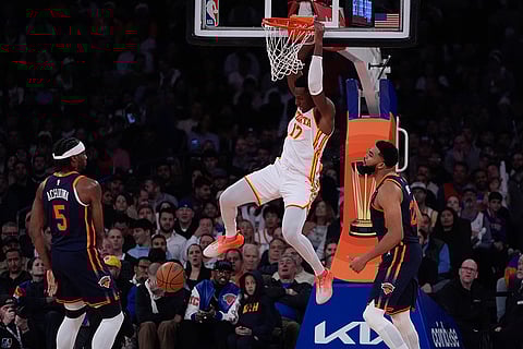 NBA Cup Quarter-Final: Hawks' Onyeka Okongwu (17) dunks the ball in front of New York Knicks' Karl-Anthony Towns and Precious Achiuwa