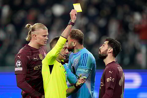 UEFA Champions League: French referee Clement Turpin shows the yellow card to Manchester City's Bernardo Silva