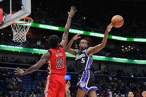 NBA: Kings guard De'Aaron Fox (5) passes the ball away from Pelicans center Yves Missi