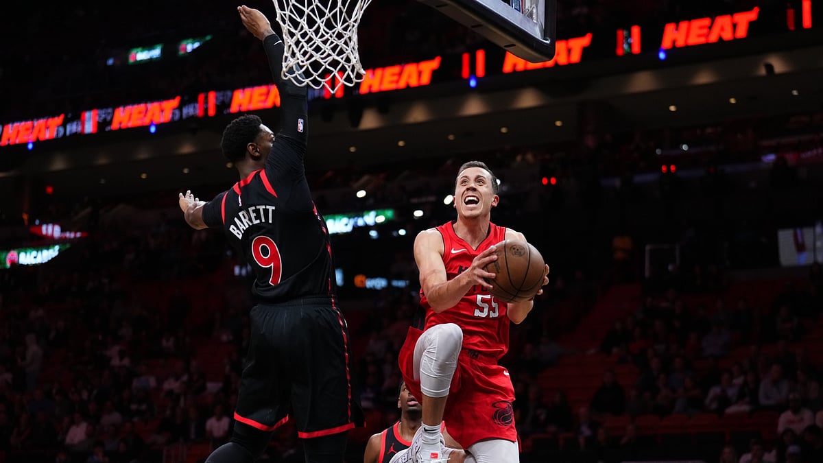 Duncan Robinson #55 of the Miami Heat goes up for a shot against RJ Barrett #9 of the Toronto Raptors during the second quarter at Kaseya Center on December 12, 2024 in Miami, Florida.