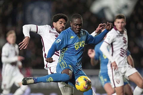 Empoli's Emmanuel Gyasi, right, and Torino's Saul Coco in action