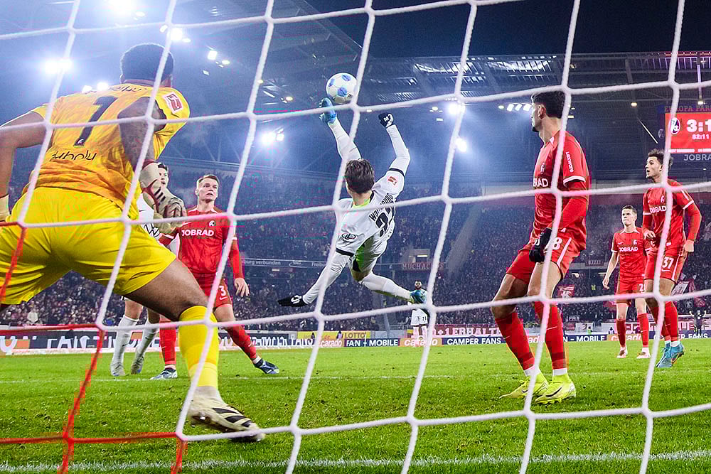 | Photo: Tom Weller/dpa via AP : Bundesliga 2024-25: Wolfsburg's Mattias Svanberg scores a goal 