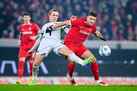 Bundesliga 2024-25: Wolfsburg's Patrick Wimmer and Freiburg's Maximilian Eggestein in action