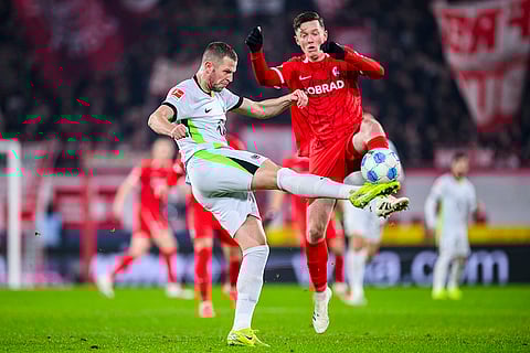 Bundesliga 2024-25: Wolfsburg's Tiago Tomas and Freiburg's Michael Gregoritsch in action